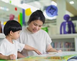A natural photograph showing children preparing for school with books and educational materials 